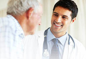 image of a man doctor smiling at his patient